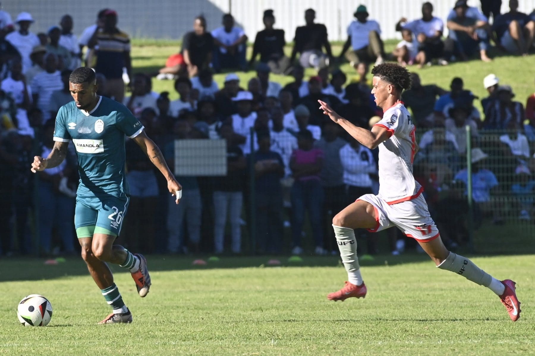 Wayde Jooste of AmaZulu controls the ball as Chippa United's Giovanni Philander closes in.