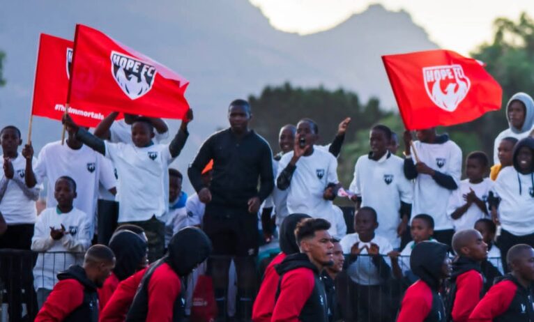 Hope FC players celebrating with their fans