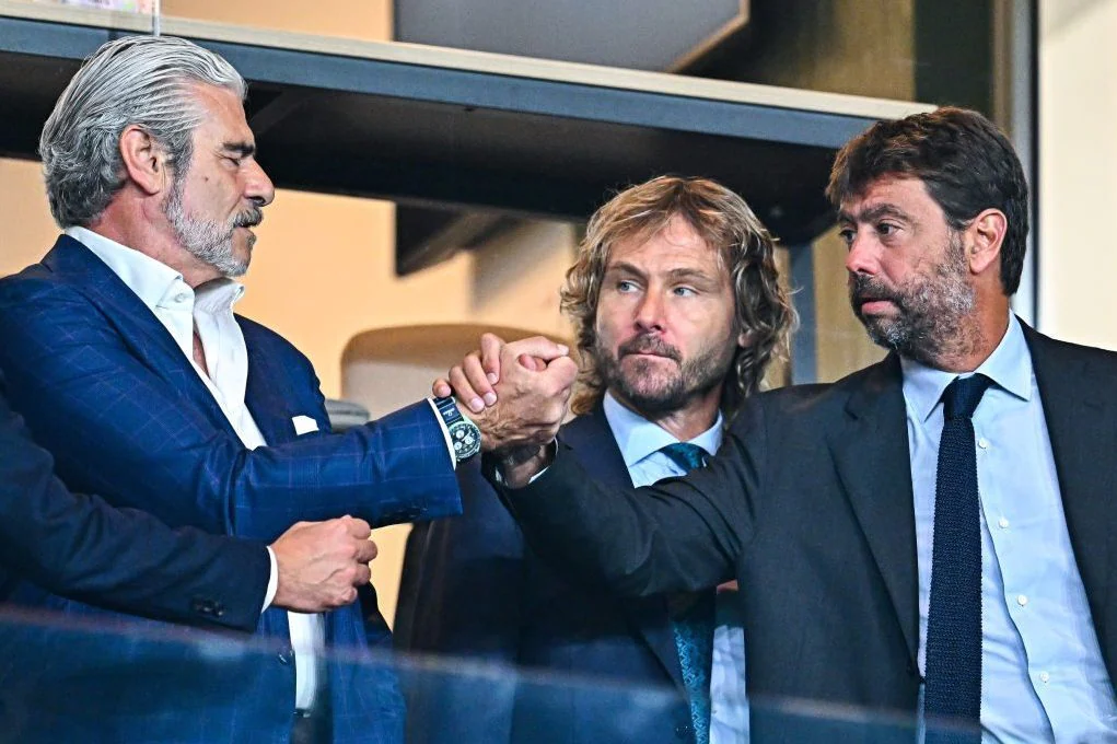 CEO of Juventus Maurizio Arrivabene [left] and club president Andrea Agnell [right], shaking hands.