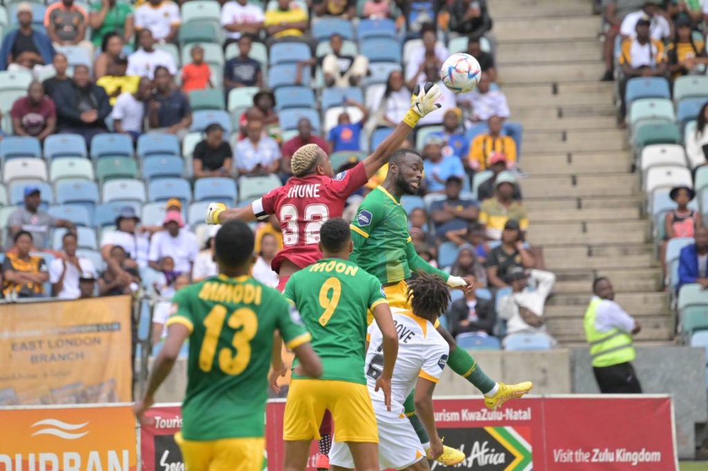 Khune parrying the ball away 