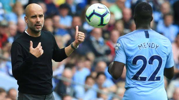 Benjamin Mendy and Pep Guardiola during a Premier League game 