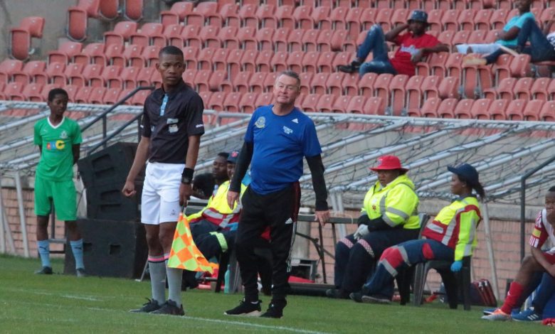 Coach Johnny Ferreira on the touchline in TTM's colours