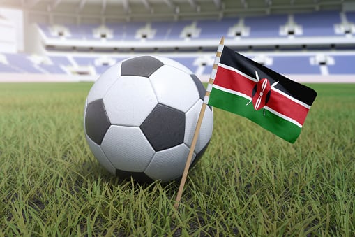 Kenyan flag in a stadium with a soccer ball