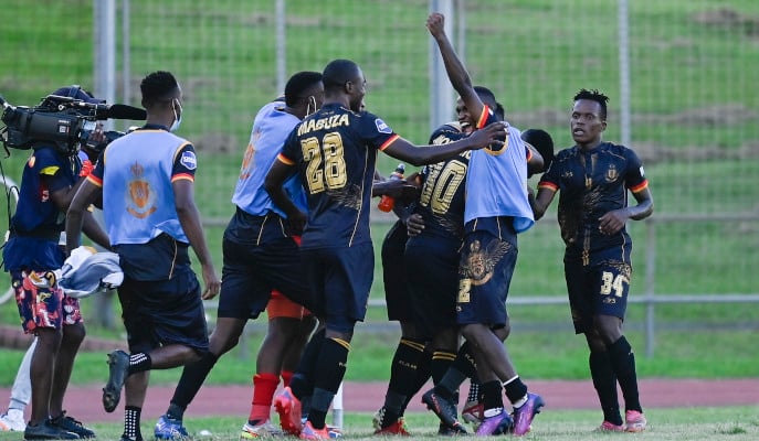 Royal AM players celebrating after scoring a goal.