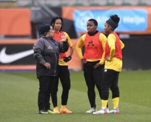 Desiree Ellis having a conversation with Banyana Banyana players