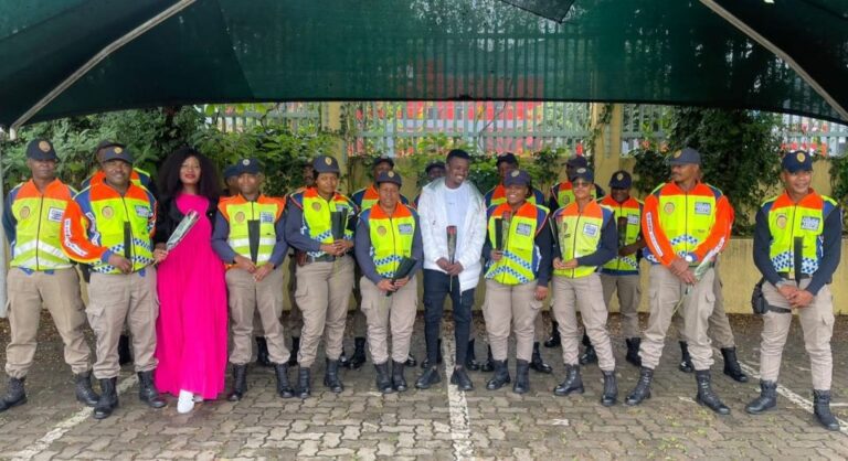 Mamelodi Sundowns, midfielder, Teboho Mokoena standing alongside Metro Police officers