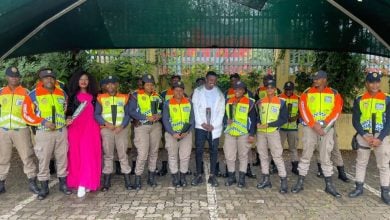 Mamelodi Sundowns, midfielder, Teboho Mokoena standing alongside Metro Police officers