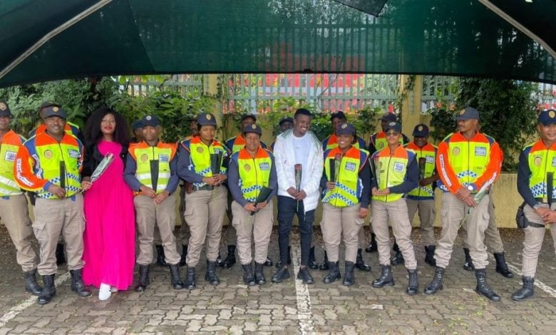 Mamelodi Sundowns, midfielder, Teboho Mokoena standing alongside Metro Police officers