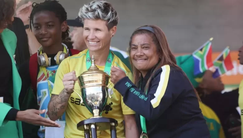 Desiree Ellis with Janine van Wyk with the AWCON trophy