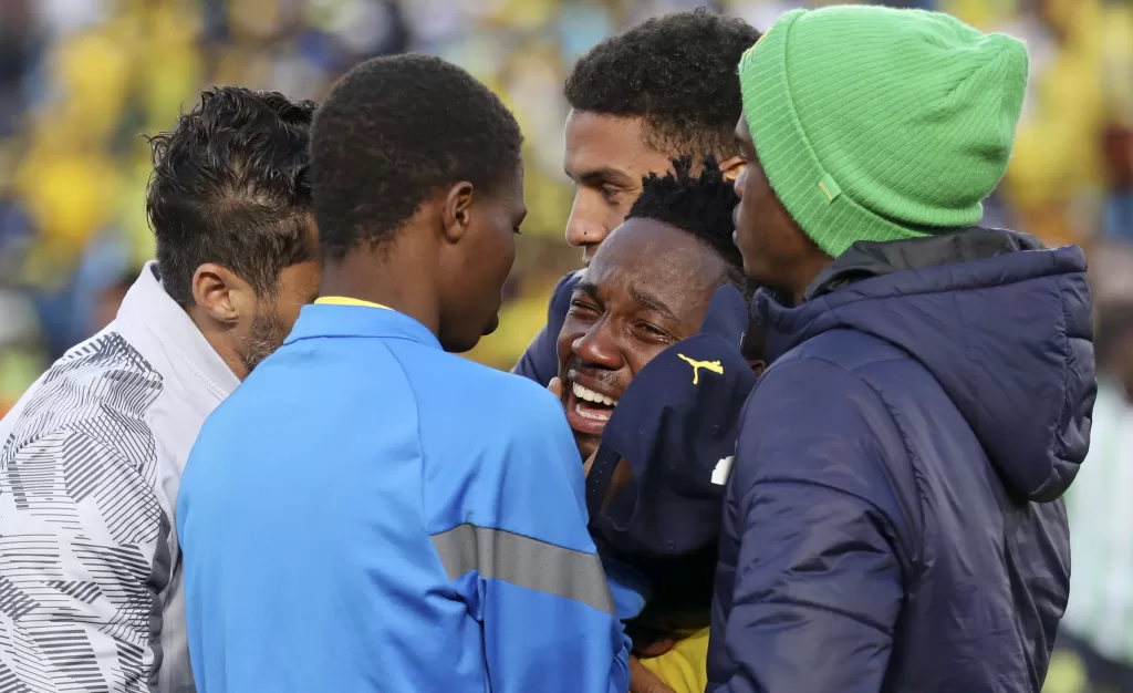 Cassius Mailula who is a fan of Themba Zwane getting comforted by his teammates 