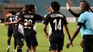 Percy Tau celebrating with teammates.