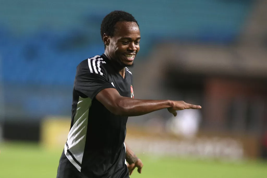 Percy Tau in the colours of Al Ahly celebrating a goal 