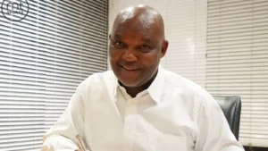 Pitso Mosimane putting pen to paper.