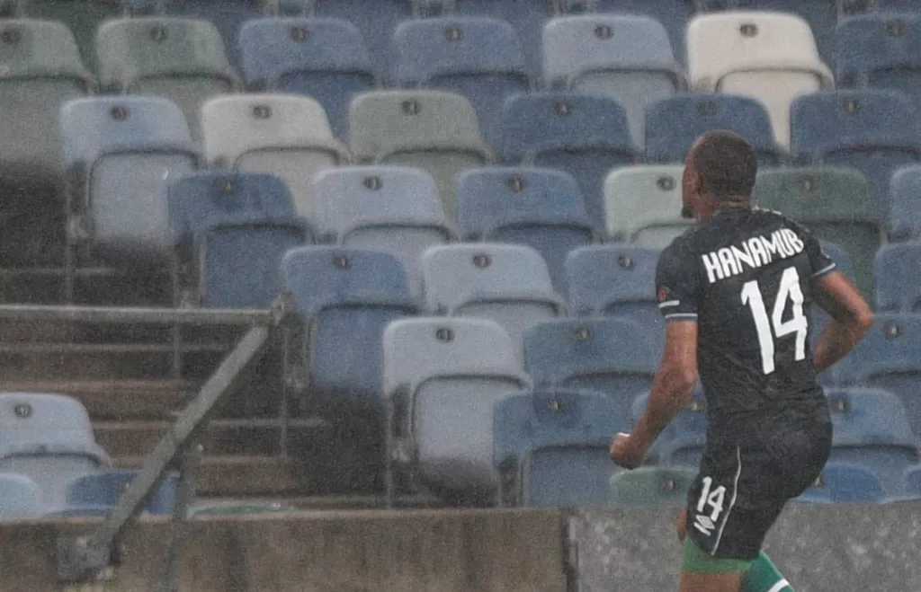Riaan Hanamub playing soccer in the rain for Orlando Pirates