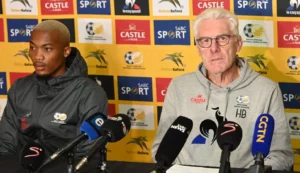 Khanyisa Mayo with Hugo Broos attending a press conference