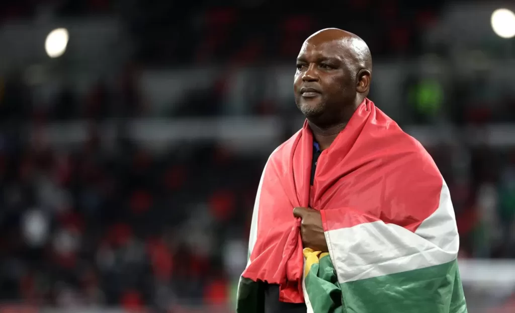 Pitso Mosimane with the SA flag after a game