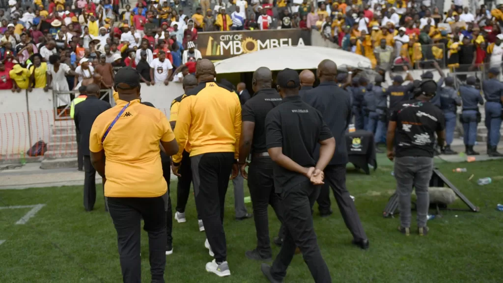 Kaizer Chiefs coach Molefi Ntseki escorted off the pitch as fans throw objects 