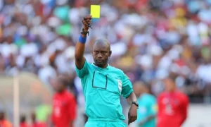 Victor Hlungwani giving out a yellow card during his refereeing times