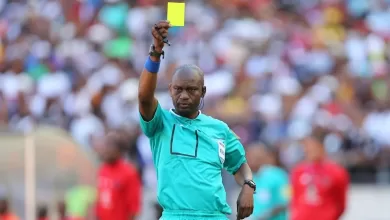 Victor Hlungwani giving out a yellow card during his refereeing times