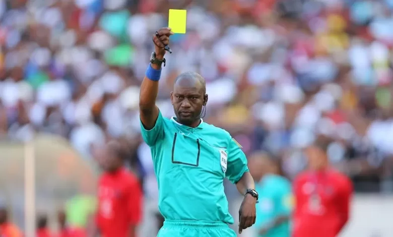 Victor Hlungwani giving out a yellow card during his refereeing times