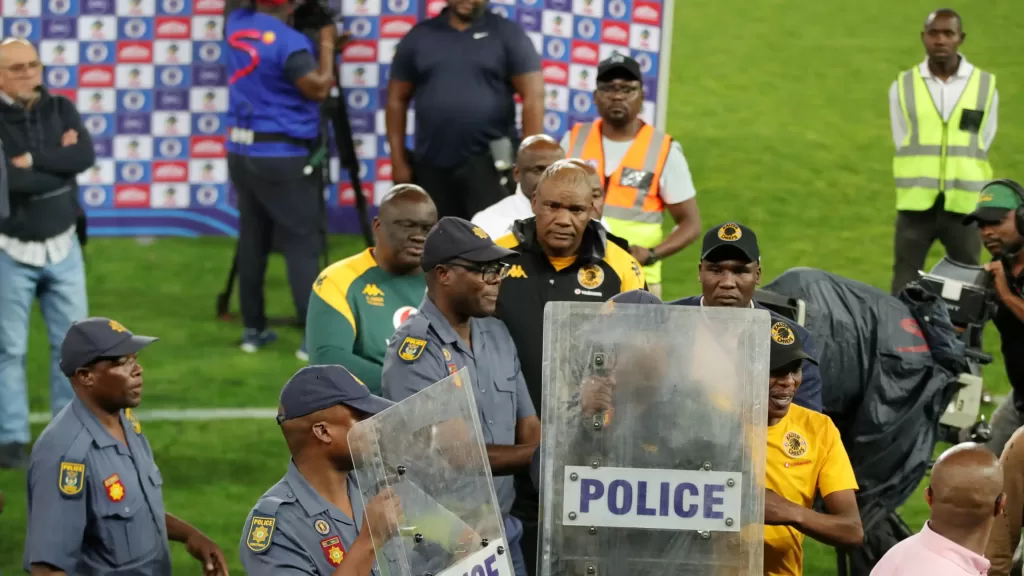 Kaizer Chiefs coach Molefi Ntseki escorted by the police