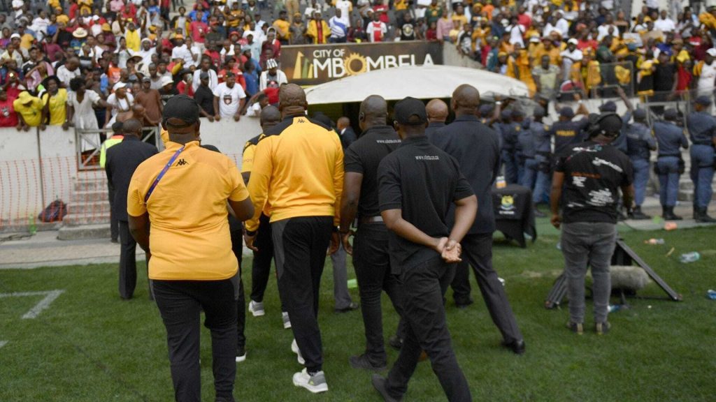 Kaizer Chiefs coach Molefi Ntseki accompanied by police into the tunnel