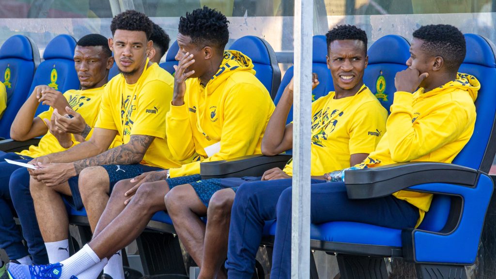 Mamelodi Sundowns players relaxing on the bench.