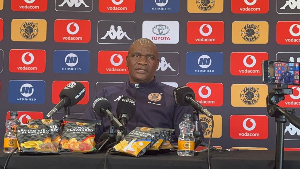 Molefi Ntseki addressing the media with the Kaizer Chiefs chips on the table