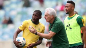 Coach Hugo Broos and Aubrey Modiba in Bafana Bafana colors.