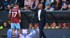 Vincent Kompany and Lyle Foster on the sidelines during a Premier League match