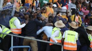 Kaizer Chiefs fans clashing with police officers.