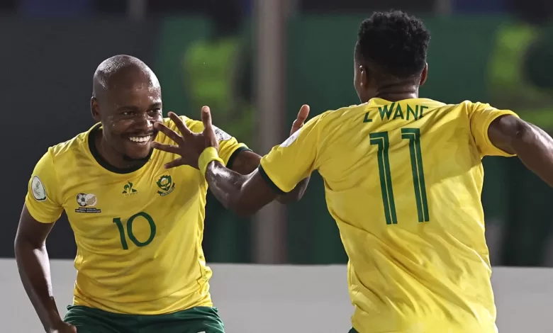 Percy Tau celebraing a goal with Bafana Bafana teammate Themba Zwane in an AFCON game
