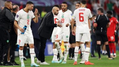 Walid Regragui with Morocco players on the sidelines during a match