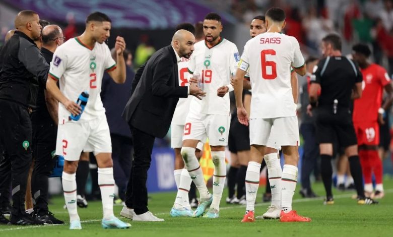 Walid Regragui with Morocco players on the sidelines during a match