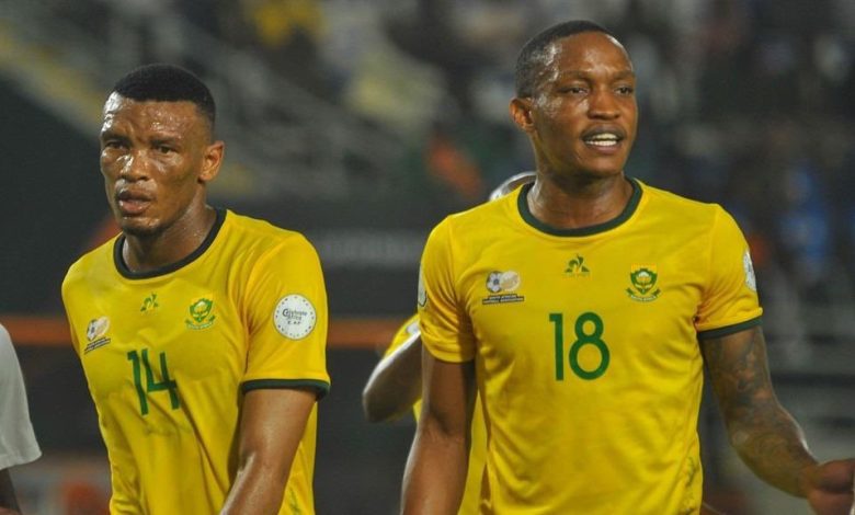 Bafana Bafana defenders Mothobi Mvala and Grant Kekana in action.
