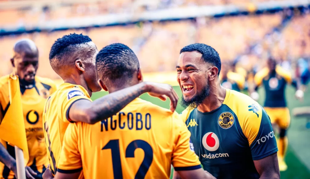 Kaizer Chiefs players celebrate a goal including Brandon Petersen and Nkosingiphile Ngcobo
