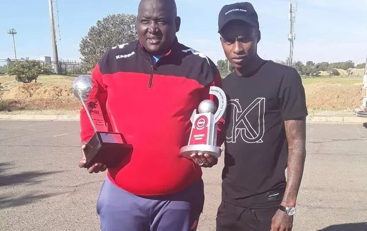 Thembinkosi Lorch shows his PSL awards to his former coach Morena Ramoreboli