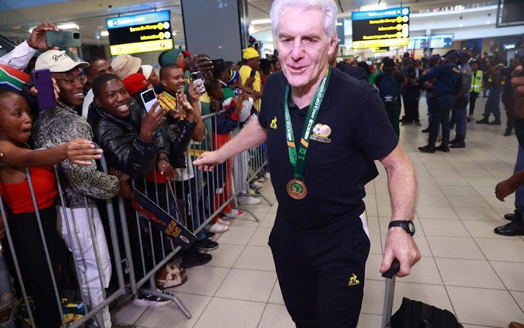 Hugo Broos of Bafana Bafana arriving back in SA