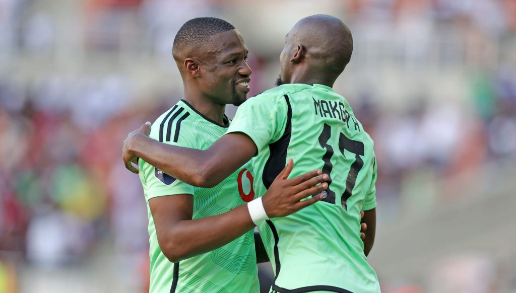 Orlando Pirates striker Tshegofatso Mabasa celebrating with a teammate