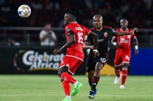 Percy Tau tussles for the ball against Simba SC