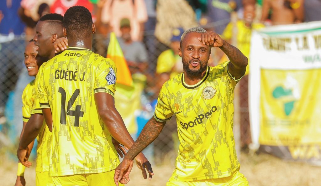 Young African players celebrate a goal