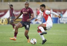 Cape Town Spurs winger Asenele Velebayi under challenge from Stellenbosch FC defender Athenkosi Mcaba