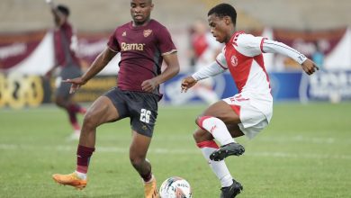 Cape Town Spurs winger Asenele Velebayi under challenge from Stellenbosch FC defender Athenkosi Mcaba