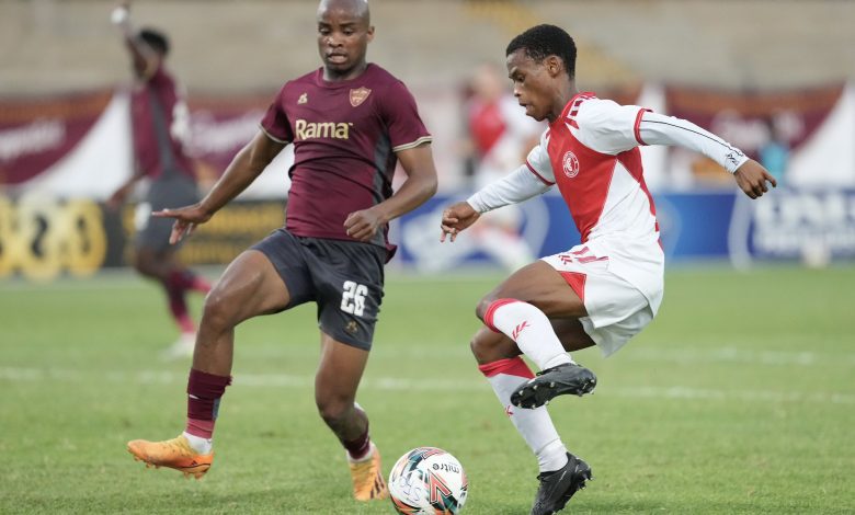 Cape Town Spurs winger Asenele Velebayi under challenge from Stellenbosch FC defender Athenkosi Mcaba