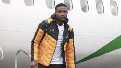 Abdi Banda walking from a plane