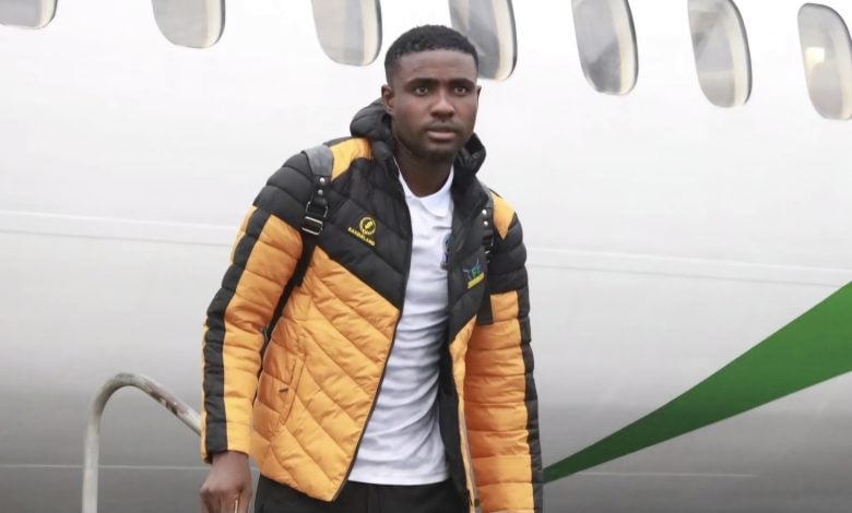 Abdi Banda walking from a plane