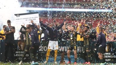 Kaizer Chiefs lifting the trophy with assistant coach Cedric Kaze