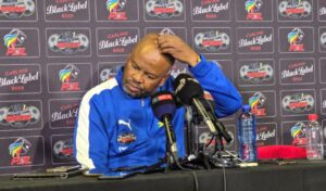 Manqoba Mngqithi scratching his head during the post match conference