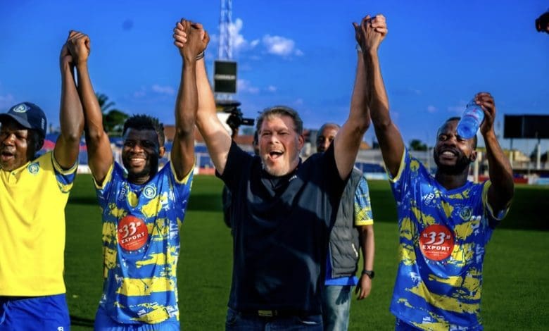 Luc Eymael with the players celebrating