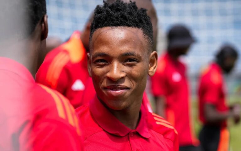 Relebohile Mofokeng of Orlando Pirates chatting with a teammate before a game